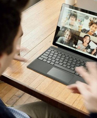 Person using Microsoft Surface tablet to participate in online video meeting