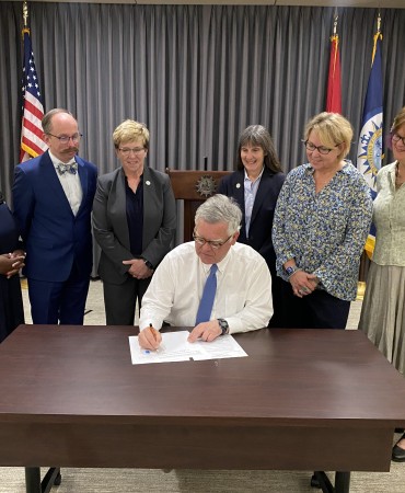 Mayor John Cooper signing Affordable Housing law with Metro Council members watching