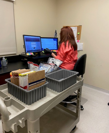 Technician working returns to evidence storage division