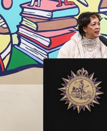 Woman standing at podium at Participatory Budgeting celebration