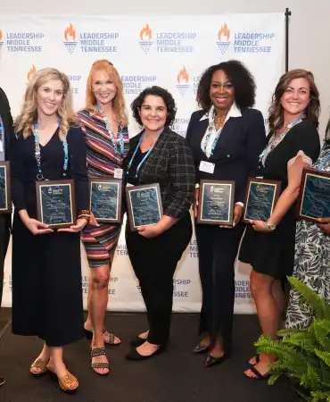 group of Leadership Middle Tennessee graduates holding plaques