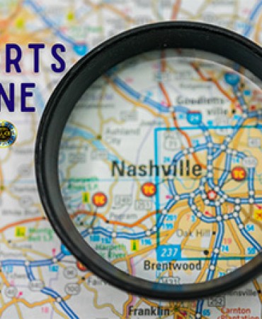 magnifying glass centered on printed map of Nashville