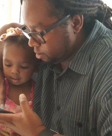 man and girl looking at cell phone