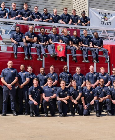 Fire Battalion 89 graduates in front of fire truck
