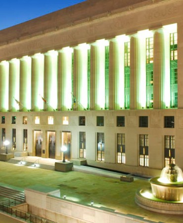 Historic Metro Courthouse lit in green at dusk