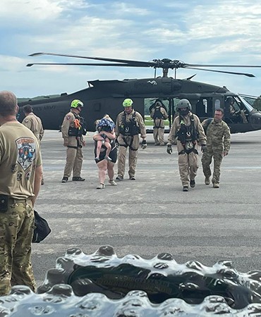 Helicopter Rescue Team walking with victim and child