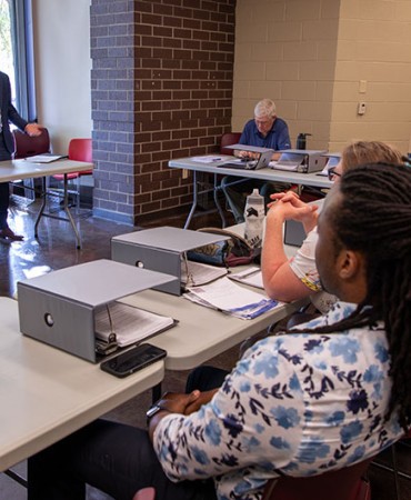 Mayor Freddie O'Connell speaking to an audience sitting at desks