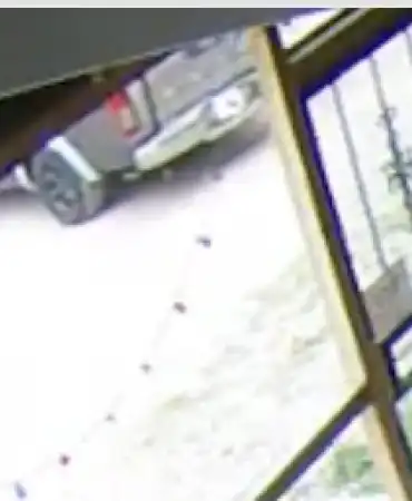 Possible 2001-2004 gray and silver Nissan Frontier with black rims
