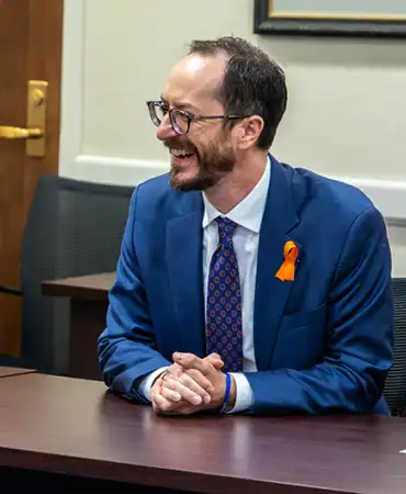 Mayor Freddie O'Connell sitting at a desk smiling