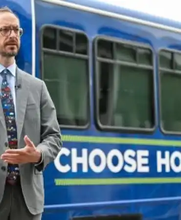 Mayor in front of Choose How You Move bus