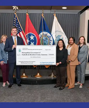 Mayor's office staff and others at a check presentation