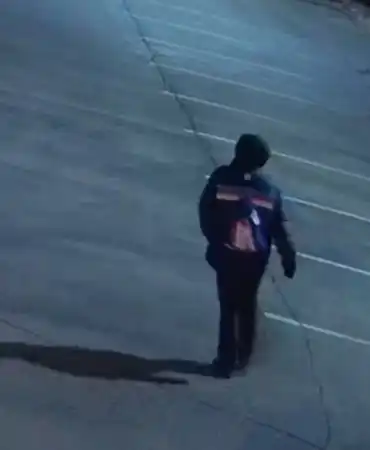 hooded figure in parking lot