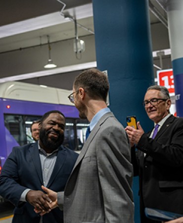 photo: Mayor O'Connell speaking with a group of men with WeGo bus in background