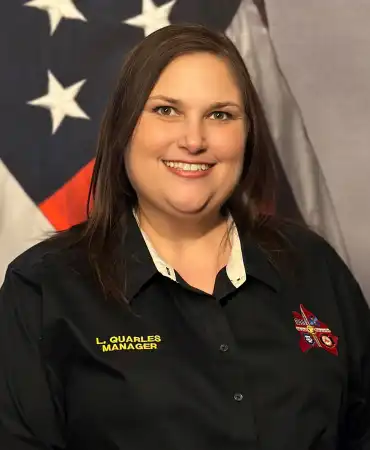woman poses for a professional headshot in front of american flag