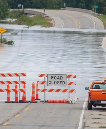 flooded road with Road Closed sign