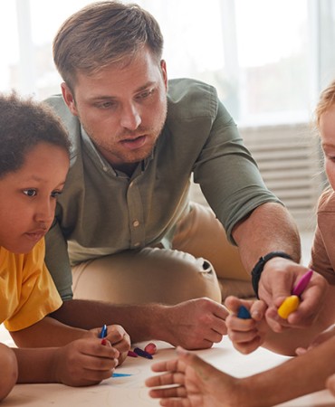 male teacher with young students