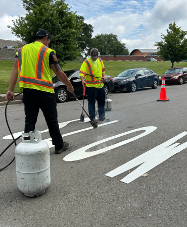 NDOT crew installing school zone markings at Explore! Community School on S 7th Street