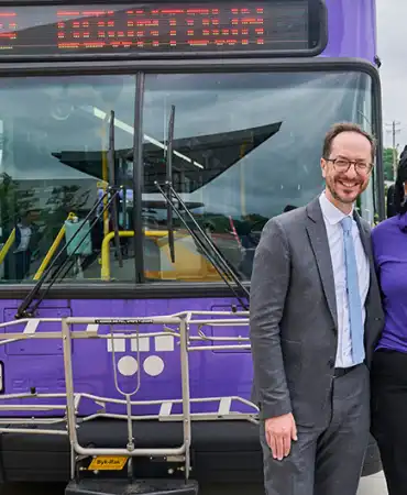 Mayor Freddie O'Connell stands with WeGo employee in front of a WeGo bus
