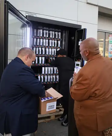 Photo of Metro Health Department Employees stocking Naloxone vending machine