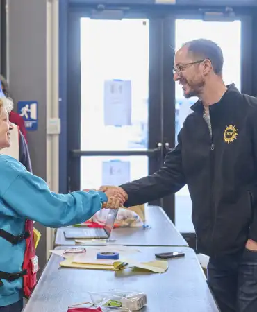 Mayor O'Connell shakes hands with a person working with the Red Cross