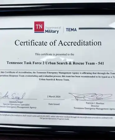 Framed Certificate of Accreditation displayed in black frame against white background.