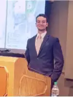 Jordan presenting from a podium.