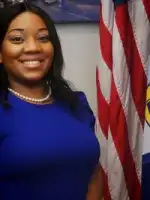 Woman standing next to a flag.