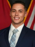 Man in a suit smiling.