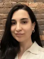 Headshot of Jihan Mohammed, set against a brick wall